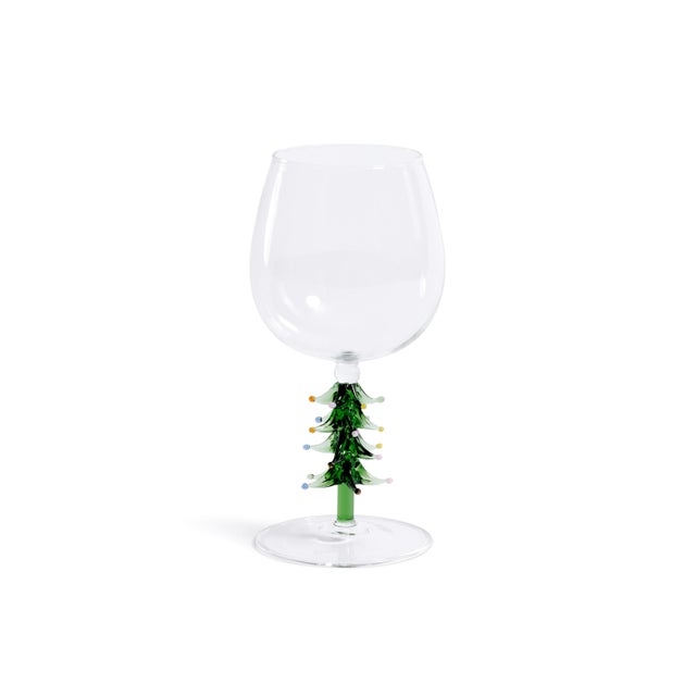Add a festive twist to your holiday table with this set of four wine glasses, each featuring a sculpted tree detail at the...