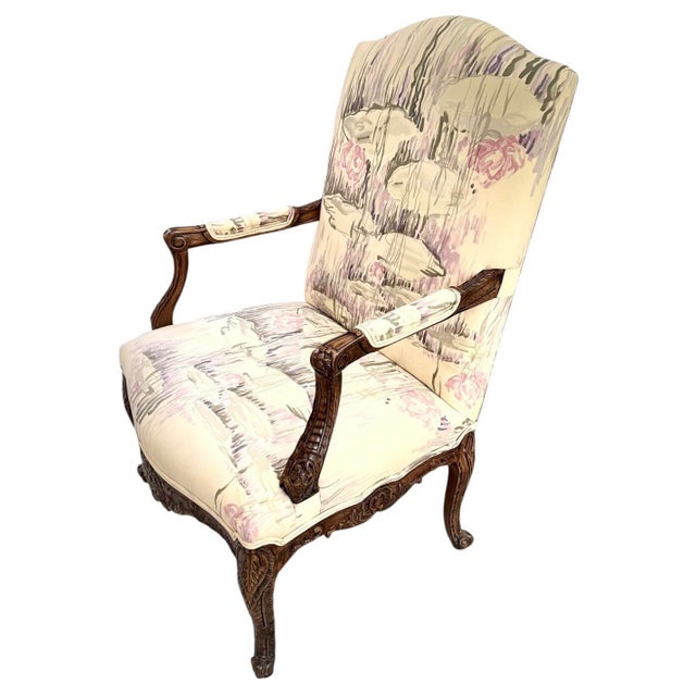 A striking pair of French Louis XV style bergère chairs featuring richly carved solid wood frames with cabriole legs,...