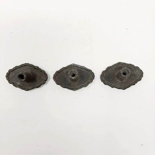 These ornately designed handles could be used on a dresser, cabinet door, or as a drawer pull. Each pull is marked "RD...