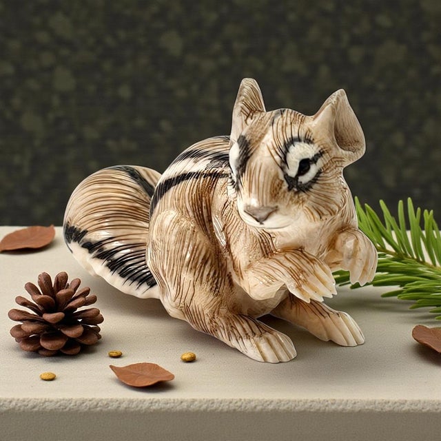 This finely executed miniature squirrel is hand carved from tagua, a dense plant-based material prized for its smooth...