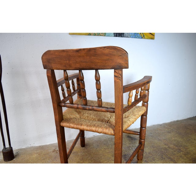 This is an antique rush-weave chair. It was made in Germany in the 1920s. The wooden frame is made of oak and has been...