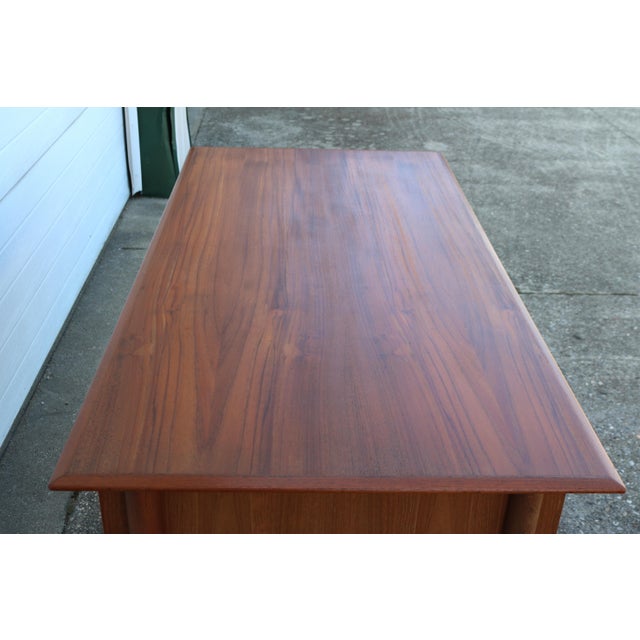 Nice teak mid-century desk made in Denmark Danish executive desk with built in bookshelf. Top and drawer fronts have been...