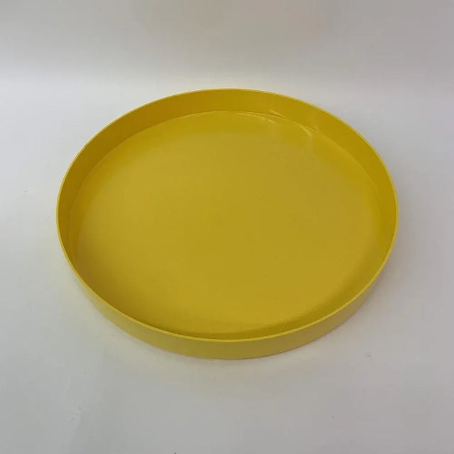 Dimensions: 38,5cm Diameter, 4,5cm H Material: Plastic Color: Yellow Origin: Denmark Period: 1970's.