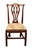 Ornate wooden back chair with a reupholstered light printed floral seat. The manufacturer and exact date of creation are...