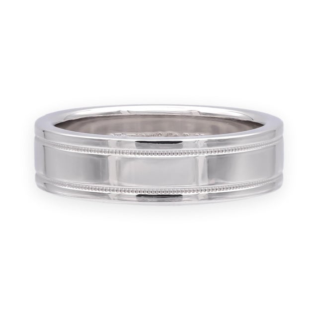 This Tiffany & Co. Classic Double Milgrain Band Ring is finely crafted in platinum, featuring a 6mm wide design with...