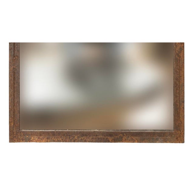 Pair of Louis XV style steel mirrors. Rusty oxidized with arched tops.