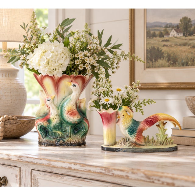 Charming matched pair of vintage Mid-Century ceramic pheasant vases featuring colorful iridescent glazes in soft pink,...