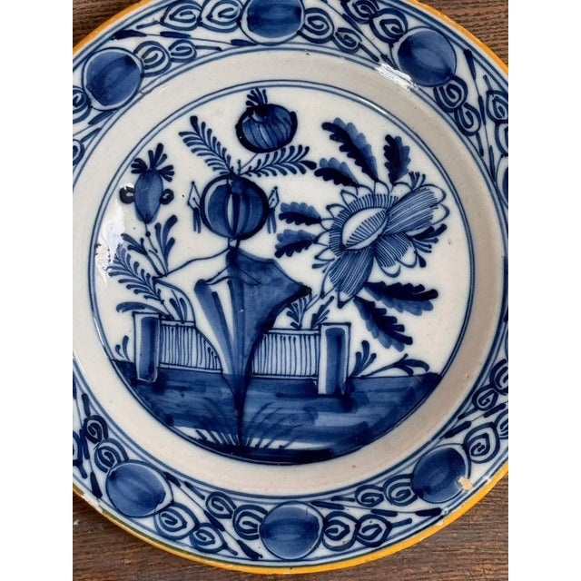 Two fine 18th Century Dutch delft plates. 9” diam.