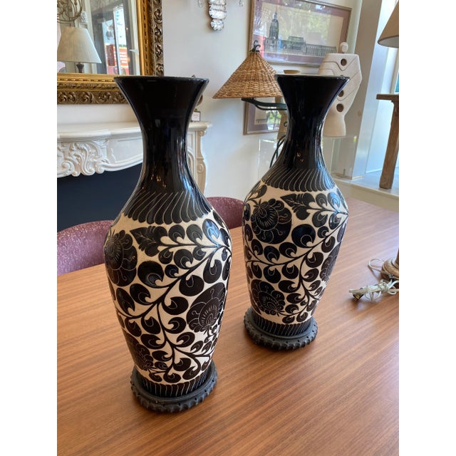 This is a pair of beautifully hand painted vases depicting flowers and vines. These have a soft cream background with...