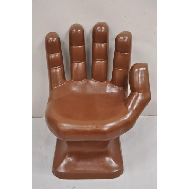 Vintage Mid Century Modern 1980s Brown Molded Plastic Hand Chair. Circa Late 20th Century. Measurements: 34.5" H x 31" W x...