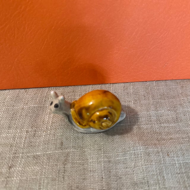 Vintage Small Ceramic Snail Figurine. Bottom is bisque unpainted clay and shell is painted and slightly glossy. Marked on...