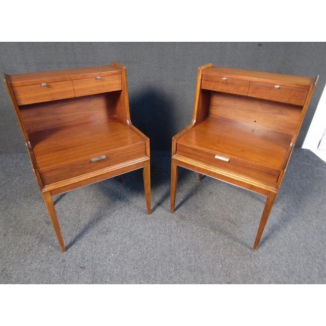 A pair of vintage Cavalier nightstands featuring tall legs and three drawers in a two-tier fashion. Wether its the...