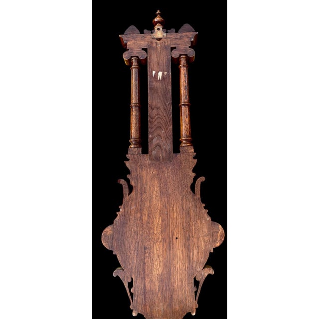 An English hand carved solid Oak Wall Hanging Barometer. Oak case has a beautifully carved crest with two acanthus...