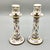 An elegant pair of sèvres-style porcelain candlesticks, beautifully hand-painted with delicate floral garlands and...