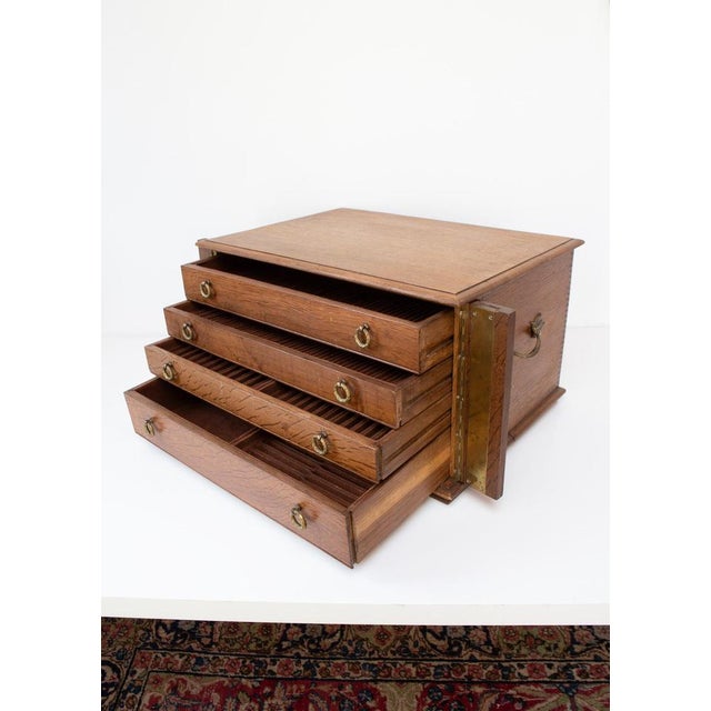 Large oak wooden case with 4 drawers and felt-lined compartments for storing cutlery for 12 people. The key and lock work...