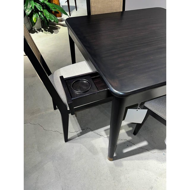 Characterized by its clean, straight lines and minimalist aesthetic. The square table has a warm hand-rubbed dark stain...