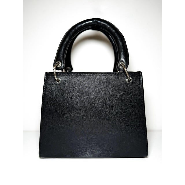 This gorgeous Vintage Chrome Hearts handbag was crafted in 1994. It features: • 3 sterling silver branded bag charms •...