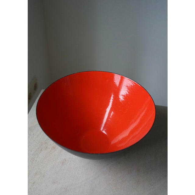 An unmarked metal Krenit bowl with red enamel interior and black exterior. This is a large size bowl. This piece is...