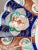 Antique plate made of Japanese Imari pottery. hand painted. Decoration with a floral motif.