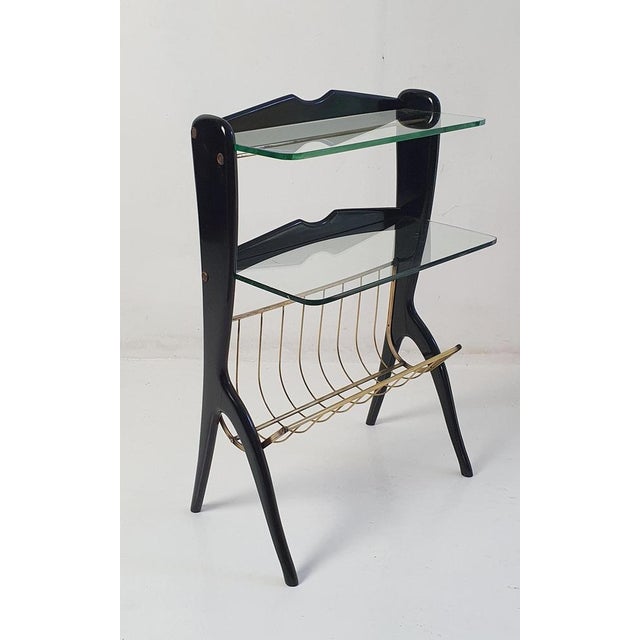 Multi-functional side table. The sleek side table has a magazine holder as well as having two solid glass shelves. Making...