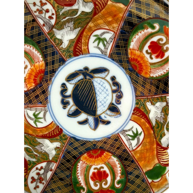 Japanese Imari porcelain dish / shallow bowl, featuring a blue peach medallion in the center and hand-painted bird...