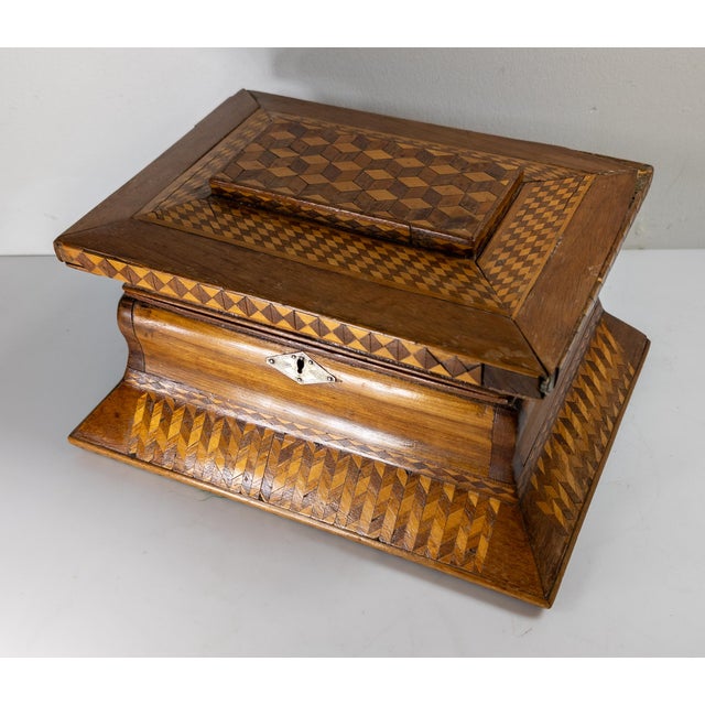 We are selling this interesting and charming folk art box. This box features geometric carved wood marquetry decorations...