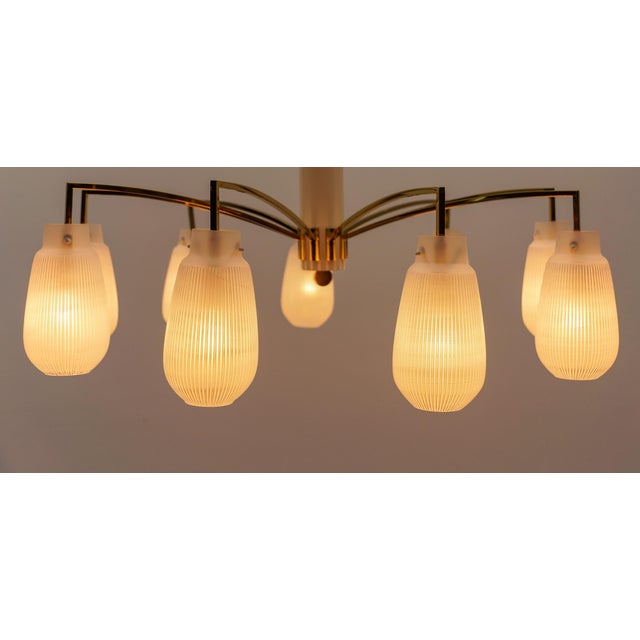 Mid-Century Modern 9-armed brass and glass Sputnik lamp, 1950 The usual slight signs of wear and a beautiful patina. The...