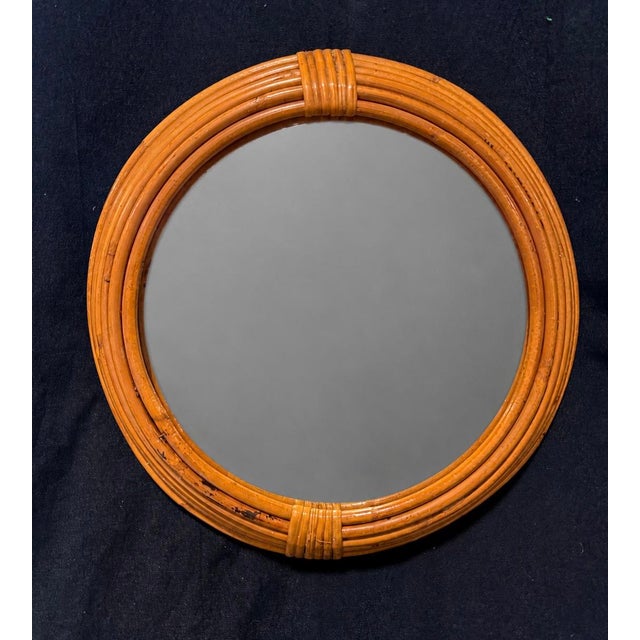 A charming French wall mirror in tightly bound rattan/cane, formed as a clean circular hoop with concentric reed courses...