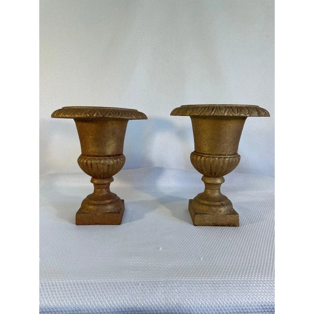 A splendid pair of gold colored Neoclassical style Jardinieres or Urns with lovely pedestal bases. Circa Mid 20th Century....