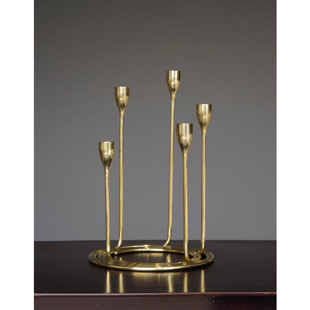 An ingenious set of five solid brass candleholders - The holders can be set out separately or in the concentric circular...
