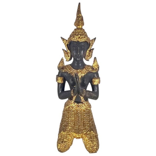 A mid-20th-century Thai Thepanom or Teppanom figure modelled as a kneeling celestial guardian or devotional attendant, its...