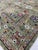 An 8' x 10' hand-knotted wool rug with a soft sage green field of scattered Oushak-style blossoms in red, blue and ivory,...