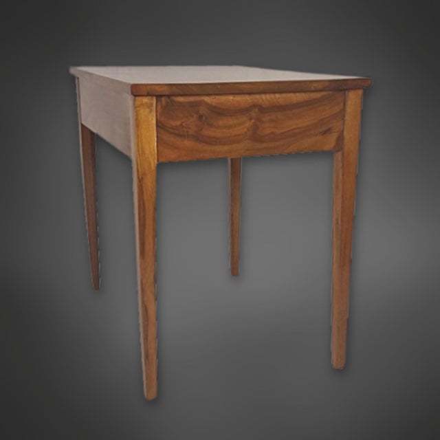 Rectangular Biedermeier table in solid walnut. Beneath the tabletop is a large drawer that spans the entire width. The...