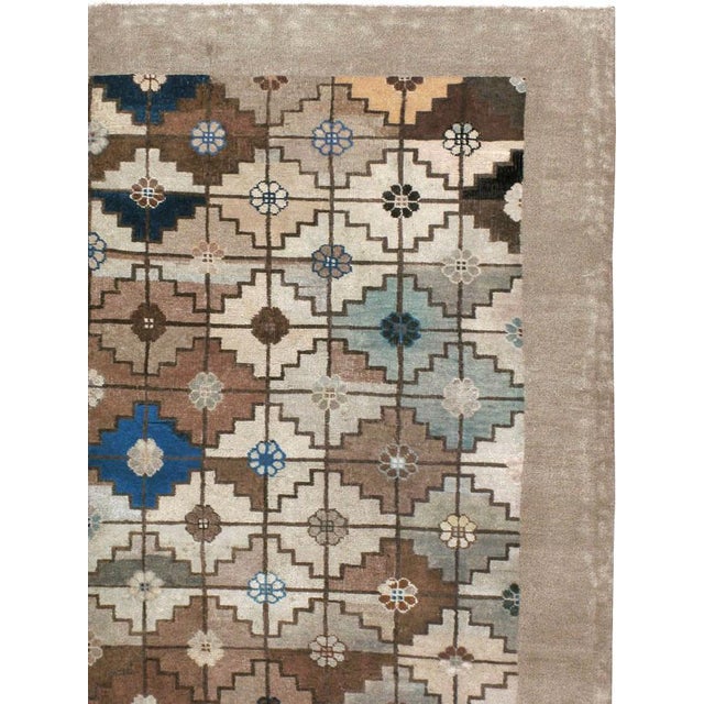 An antique Mongolian room size carpet handmade during the early 20th century with a contemporary Art Deco style geometric...
