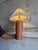 This charming ceramic table lamp features a textured orange base and pleated shade. The warm silhouette brings cozy...