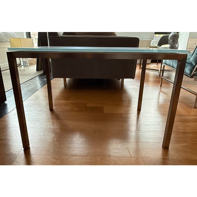 Description: Room & Board Parsons end table with a white opaque glass top and 1.5" brushed stainless steel legs. Clean and...