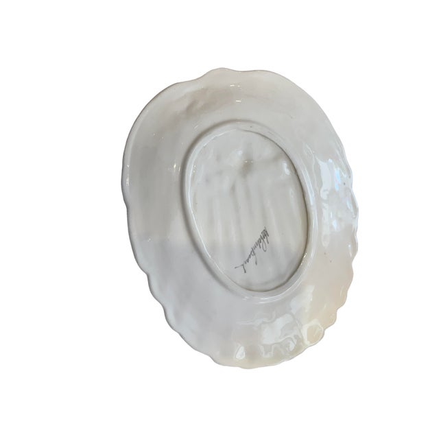 Charming and feminine, this sculptural ceramic platter features a softly ruffled silhouette with hand-painted blush pink...