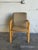 This comfortable armchair showcases a clean wooden frame paired with textured fabric upholstery. The organic lines and...