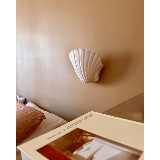 Pair of matte white plaster shell-shaped wall sconces, produced in France in the 1970s. Timeless design, indirect...
