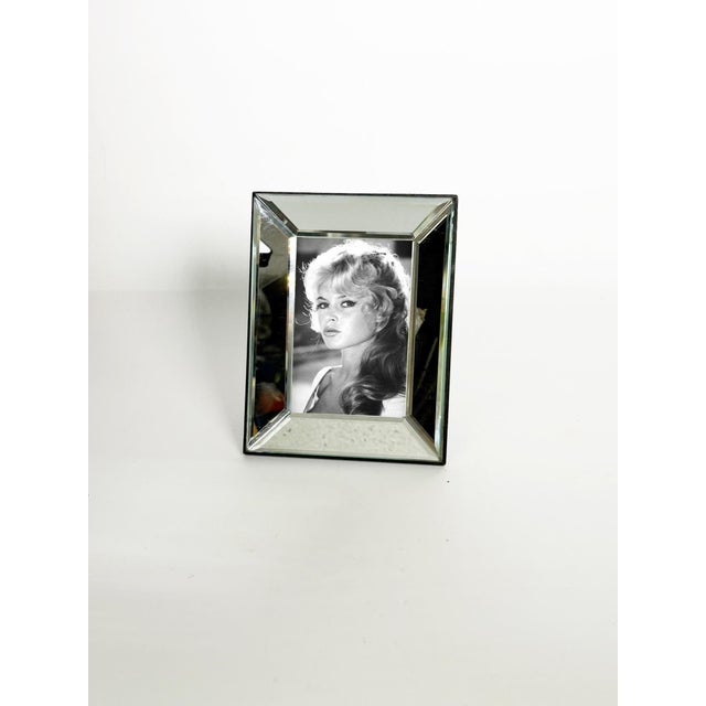 Beveled mirror photo frame, France, 1980s. The photo is not provided. An elegant beveled mirror photo frame, typical of...