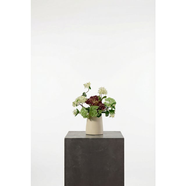 A moody yet fresh composition of burgundy hydrangea, green snowball, and pale lilac. The deeper tones are balanced by soft...