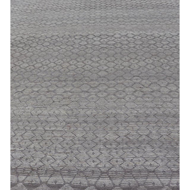 This modern casual Moroccan rug has been hand-knotted in wool. The rug features a modern all-over sub-geometric hexagonal...