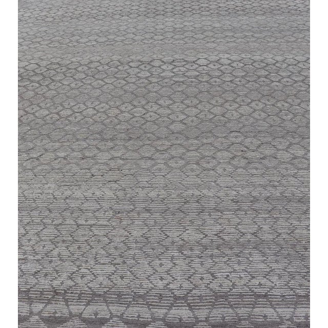 This modern casual Moroccan rug has been hand-knotted in wool. The rug features a modern all-over sub-geometric hexagonal...