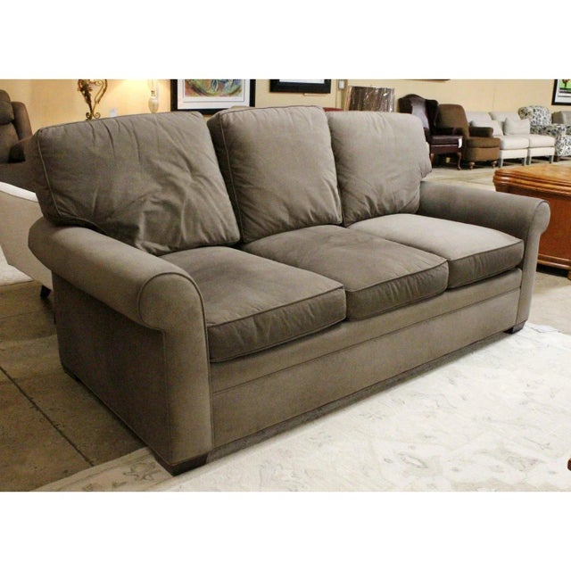 Featuring a casual, transitional design, this piece is upholstered in a dark gray fabric with gently rolled arms and a...