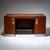 Large desk on a brushed metal base and lockable compartments on the sides. The handles are made of a smooth metal plates...