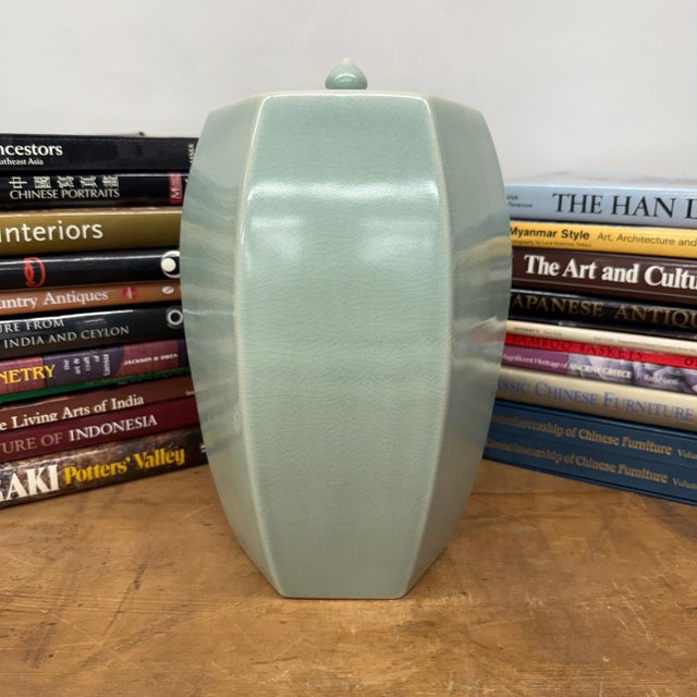 "About This Piece About This Piece This porcelain jar brings together the balance of symmetry and the gentle touch of...