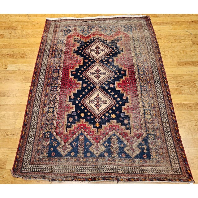 "A beautifully woven vintage Persian Afshar tribal area rug from the early 20th century, showcasing a bold and intricately...