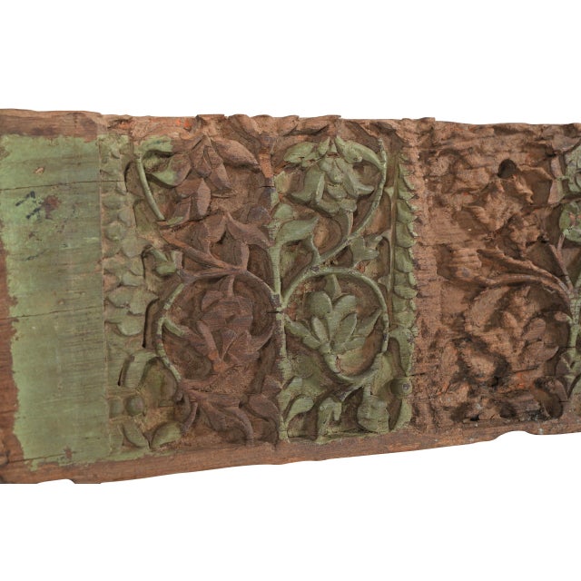 This Antique Indian Carved Teakwood Panel is hand-carved from solid teakwood, featuring a continuous series of intricate...