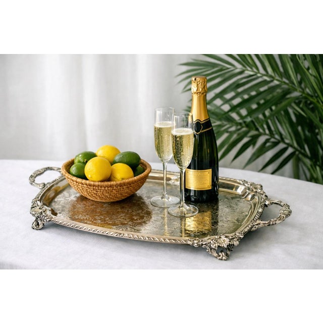 A spectacular oversized F.B. Rogers silverplate butler tray, measuring 27.75” wide including handles x 17” deep, elevated...