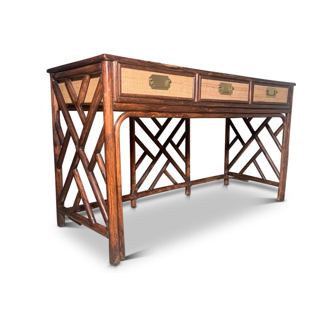 Mid-century organic rattan three drawer glazed vanity with a stained faux bamboo wooden frame. Finished with a glazed...